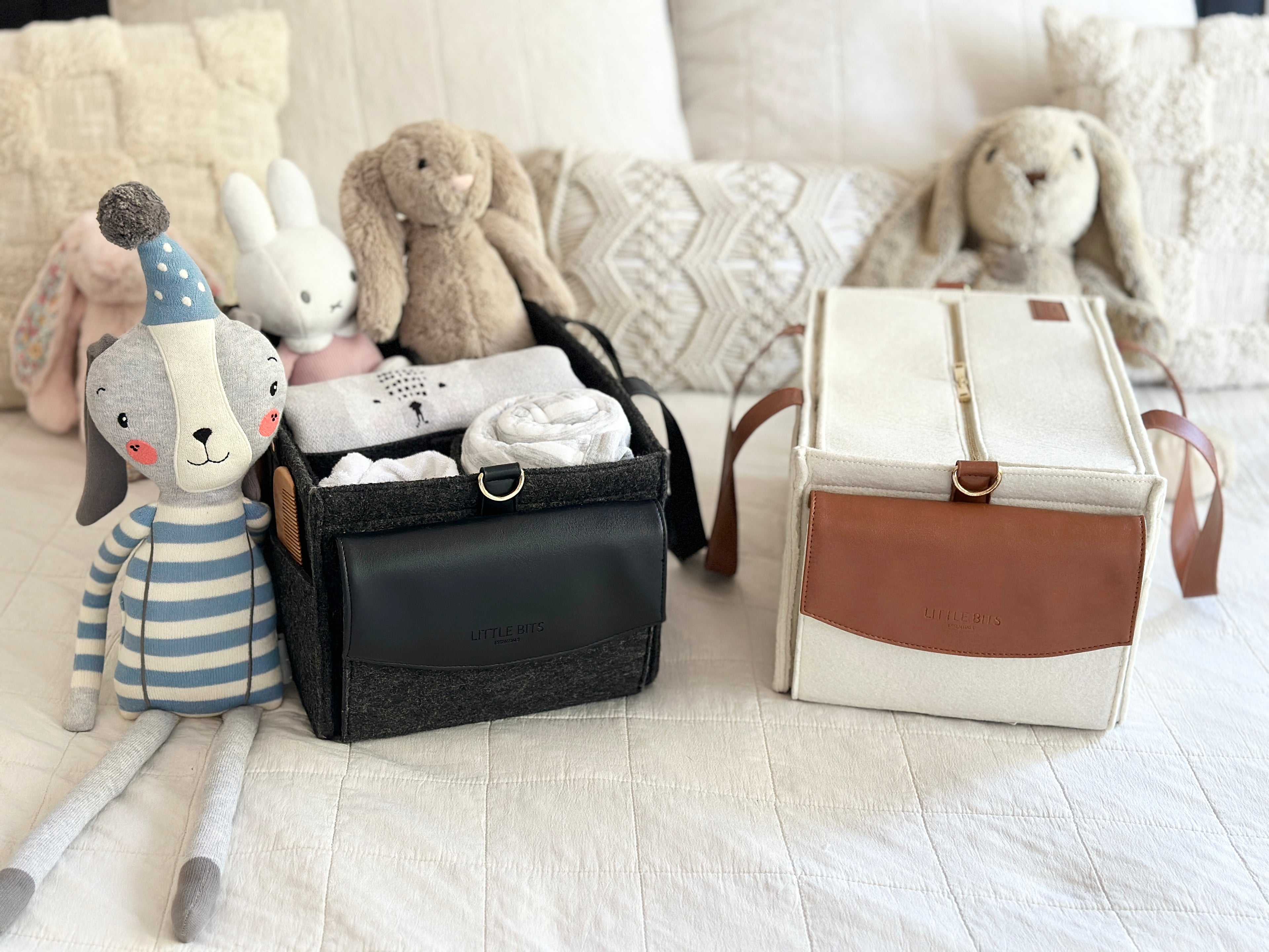 The Caddy Bags on a bed filled with essentials
