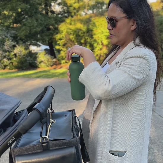 Mum and Baby with The Caddy Bag attached to pram, out at the park