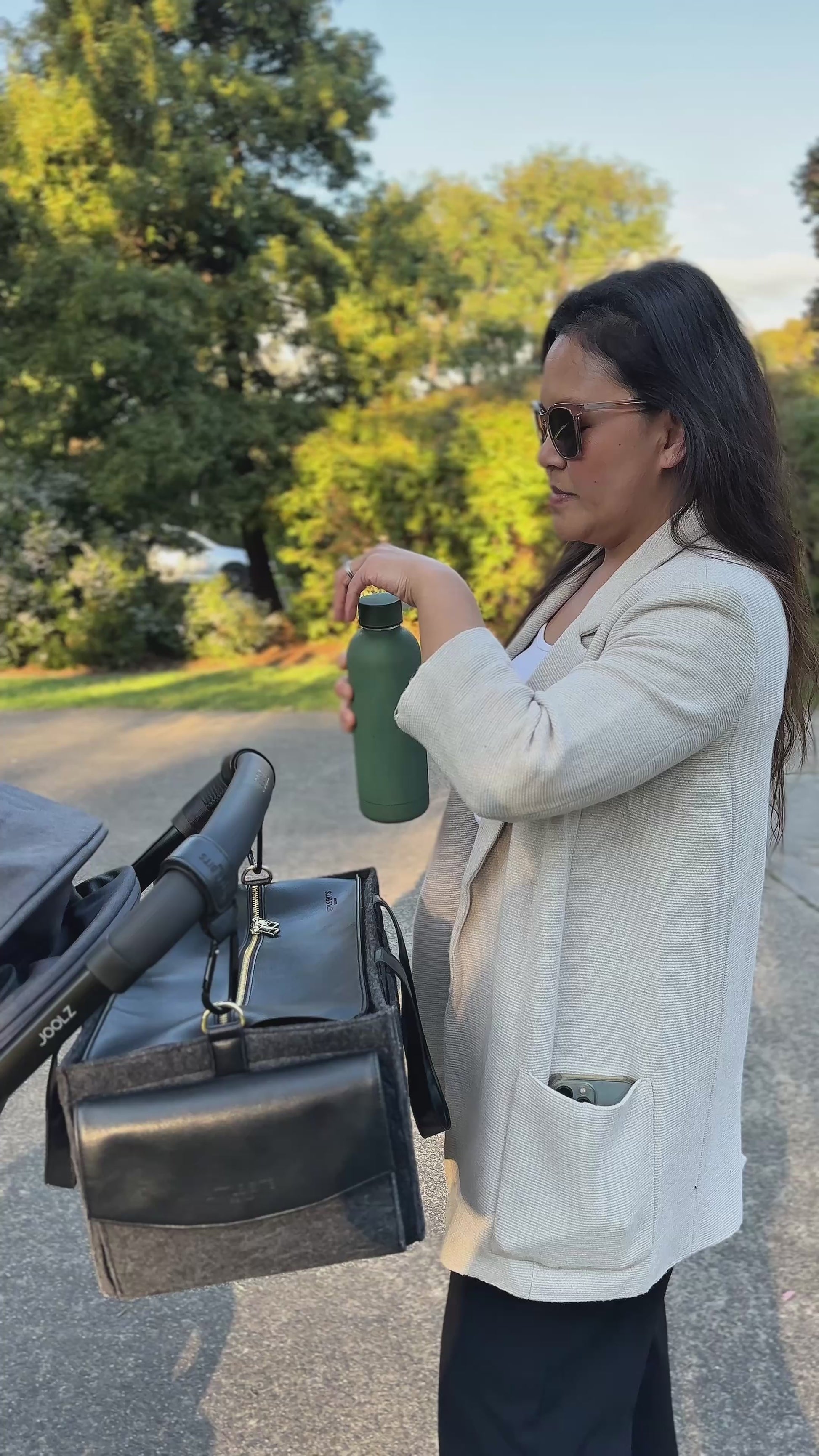 Mum and Baby with The Caddy Bag attached to pram, out at the park