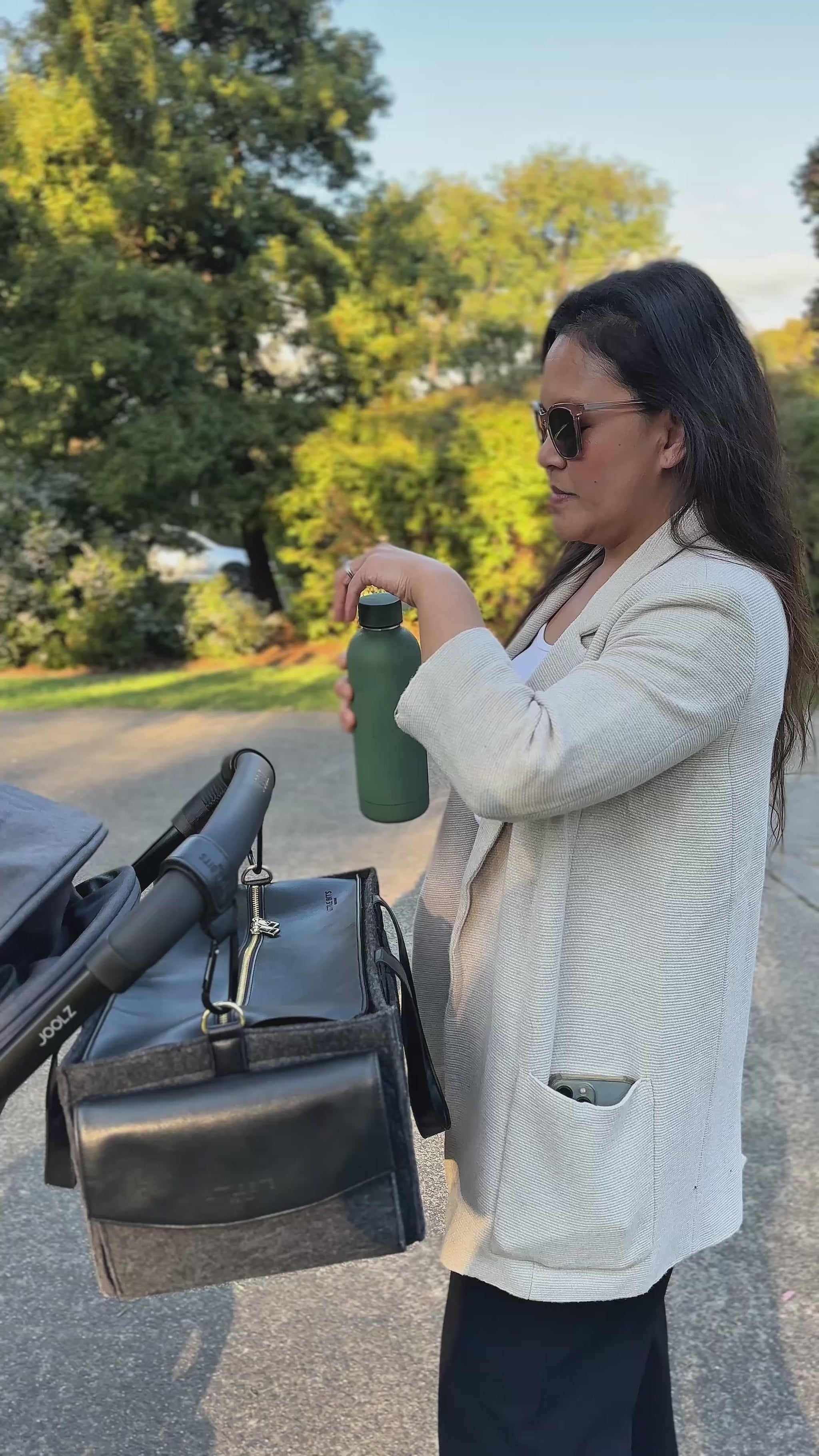 Mum and Baby with The Caddy Bag attached to pram, out at the park